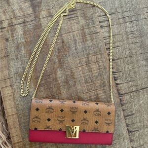 MCM Tracy wallet on gold chain with red and brown leather.
